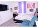 Cozy bedroom with soft carpeting, a comfortable bed, soft purple accents, and personal decor at 673 Sarner Pass Way, Winter Haven, FL 33881