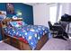 Comfortable bedroom with a unique bed frame, colorful bedding, and a dedicated workspace at 673 Sarner Pass Way, Winter Haven, FL 33881