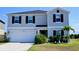 Inviting two-story home with a two-car garage, well-maintained lawn, and welcoming front entrance at 673 Sarner Pass Way, Winter Haven, FL 33881