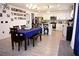 A bright kitchen with white cabinets, stainless steel appliances, and an island with bar seating adjacent to a dining area at 673 Sarner Pass Way, Winter Haven, FL 33881