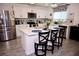 Modern kitchen featuring stainless steel appliances, white cabinets, an island with bar seating, and stylish decor at 673 Sarner Pass Way, Winter Haven, FL 33881