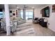 Open living room featuring hardwood floors, a large window, and modern decor at 673 Sarner Pass Way, Winter Haven, FL 33881