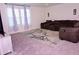 Spacious living room featuring comfortable seating, plush carpeting, and ample natural light from the windows at 673 Sarner Pass Way, Winter Haven, FL 33881