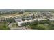 Beautiful aerial view of the condo community nestled among lush landscaping and a well-manicured golf course at 7509 Mourning Dove Cir # 303, Reunion, FL 34747
