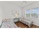 bedroom with two twin beds, neutral walls, and wood flooring at 7509 Mourning Dove Cir # 303, Reunion, FL 34747