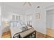 Bright bedroom featuring a queen bed, bench, and walk-in closets at 7509 Mourning Dove Cir # 303, Reunion, FL 34747