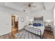 Bedroom with ensuite bathroom, hardwood floors, walk-in closet and neutral paint colors at 7509 Mourning Dove Cir # 303, Reunion, FL 34747