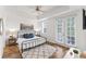 Bright bedroom features a tray ceiling, wood floors, and doors to a private balcony at 7509 Mourning Dove Cir # 303, Reunion, FL 34747