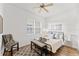 Cozy bedroom with a ceiling fan, natural light, and hardwood floors at 7509 Mourning Dove Cir # 303, Reunion, FL 34747