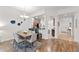 Dining room with table and chairs, opening to a full kitchen and hall at 7509 Mourning Dove Cir # 303, Reunion, FL 34747