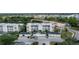 An aerial view of the condo buildings featuring attached garages and beautiful landscaping at 7509 Mourning Dove Cir # 303, Reunion, FL 34747