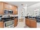 Galley kitchen with stainless steel oven, microwave, and sink at 7509 Mourning Dove Cir # 303, Reunion, FL 34747