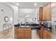 Kitchen with wood cabinets, stainless steel appliances, and black granite countertops at 7509 Mourning Dove Cir # 303, Reunion, FL 34747