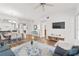 Living room with dining space, featuring wood floors and neutral decor at 7509 Mourning Dove Cir # 303, Reunion, FL 34747