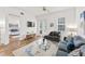 Cozy living room with natural light and a view into the adjacent bedroom at 7509 Mourning Dove Cir # 303, Reunion, FL 34747