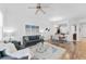 Open living area with a ceiling fan, couches, and a dining area at 7509 Mourning Dove Cir # 303, Reunion, FL 34747