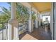 Covered balcony with tile flooring, stately columns, and black wrought iron railing at 7550 Gathering Dr, Reunion, FL 34747