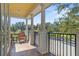 Outdoor balcony with columns, tile flooring, wrought iron railing and scenic view at 7550 Gathering Dr, Reunion, FL 34747