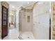 Elegant bathroom with a glass-enclosed shower, tiled walls, and a decorative built in cabinet at 7550 Gathering Dr, Reunion, FL 34747