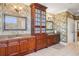 Elegant bathroom featuring and granite sinks, custom cabinetry and neutral walls at 7550 Gathering Dr, Reunion, FL 34747
