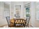 Cozy breakfast nook featuring an eye-catching round table, brightened by sunny windows at 7550 Gathering Dr, Reunion, FL 34747