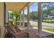 Covered front porch with brick pavers and classic columns, perfect for relaxing outdoors at 7550 Gathering Dr, Reunion, FL 34747