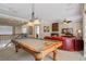 Large game room with pool table, wet bar, and red leather sofas for lounging at 7550 Gathering Dr, Reunion, FL 34747