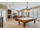 Spacious game room featuring a pool table, wet bar, and comfortable seating area at 7550 Gathering Dr, Reunion, FL 34747