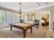Game room with a billiard table, stylish lighting, and access to other rooms at 7550 Gathering Dr, Reunion, FL 34747