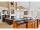 Open-concept kitchen with granite countertops, a breakfast bar, and a view of the living room fireplace at 7550 Gathering Dr, Reunion, FL 34747