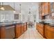 Spacious kitchen features wood cabinetry, granite countertops, and a dining area with natural light at 7550 Gathering Dr, Reunion, FL 34747
