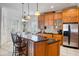 Bright kitchen with granite counters, wooden cabinets, stainless steel appliances and adjacent breakfast nook at 7550 Gathering Dr, Reunion, FL 34747