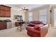 Comfortable living area with a wet bar, large TV, and red leather furniture at 7550 Gathering Dr, Reunion, FL 34747