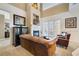 Open-concept living space with fireplace, large windows, and access to the backyard at 7550 Gathering Dr, Reunion, FL 34747
