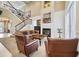 Spacious living room with a fireplace, staircase, and high ceilings at 7550 Gathering Dr, Reunion, FL 34747