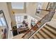 Open concept living room, with dining area, kitchen, with stair access and ample natural light at 7550 Gathering Dr, Reunion, FL 34747