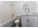 Clean bathroom with a white tiled tub and shower combo, toilet, and vanity with a mirror at 7728 Stone Creek Trl, Kissimmee, FL 34747