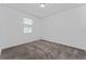Cozy bedroom featuring neutral carpet flooring and a window for natural light at 7728 Stone Creek Trl, Kissimmee, FL 34747