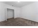 Bedroom featuring neutral carpet flooring and a spacious closet with ample storage at 7728 Stone Creek Trl, Kissimmee, FL 34747