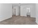 Large room featuring carpet flooring, neutral walls, and a laundry room in the hallway at 7728 Stone Creek Trl, Kissimmee, FL 34747