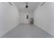 A spacious garage featuring a gray floor, white walls, water heater, and access door at 7728 Stone Creek Trl, Kissimmee, FL 34747