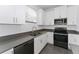 Well-appointed kitchen with stainless steel appliances, gray countertops, and white cabinets at 7728 Stone Creek Trl, Kissimmee, FL 34747