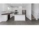 Modern kitchen featuring white cabinetry, stainless steel appliances, and a center island at 7728 Stone Creek Trl, Kissimmee, FL 34747