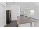 Open kitchen featuring a large island, stainless steel refrigerator, and plenty of cabinet space at 7728 Stone Creek Trl, Kissimmee, FL 34747