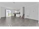 Open-concept living and dining area with tile floors, a sliding glass door, and easy access to the kitchen at 7728 Stone Creek Trl, Kissimmee, FL 34747