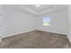 Bright main bedroom with tray ceilings, neutral carpet flooring, and a window for natural light at 7728 Stone Creek Trl, Kissimmee, FL 34747