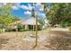 Cozy backyard with fire pit and string lights, perfect for outdoor entertaining and relaxation at 906 Elm Forest Dr, Minneola, FL 34715