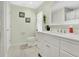 Bright bathroom featuring a white vanity, tiled floors, and tasteful decor at 906 Elm Forest Dr, Minneola, FL 34715