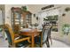 Comfortable dining area with a wooden table set, hutch, and a pleasant view of the backyard at 906 Elm Forest Dr, Minneola, FL 34715