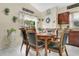 Cozy dining area with wooden table, comfortable chairs, and a view of the backyard at 906 Elm Forest Dr, Minneola, FL 34715